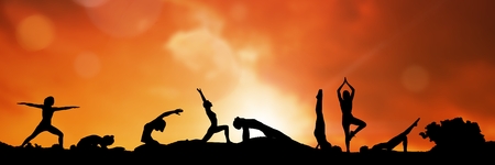 Digital composite of yoga group silhouette at sunsetの写真素材