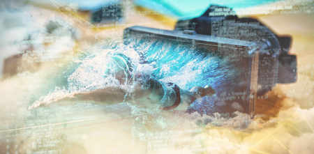 Fit swimmer training by himself against virtual reality headset on deskの写真素材