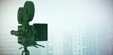 Close-up of tripod with film reel camera against sunlight falling on towers in cityの写真素材