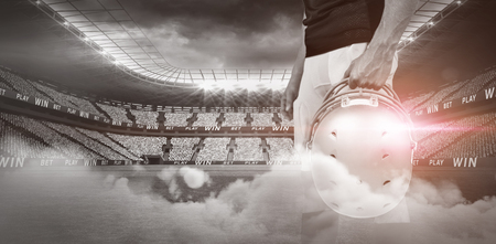 Illuminated soccer stadium against cloudy skyの写真素材