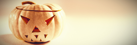 Close up of jack o lantern on white background during autumnの写真素材