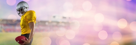 Digital composite of American football player with stadium transitionの写真素材