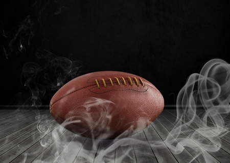 Digital composite of american football in smokeの写真素材
