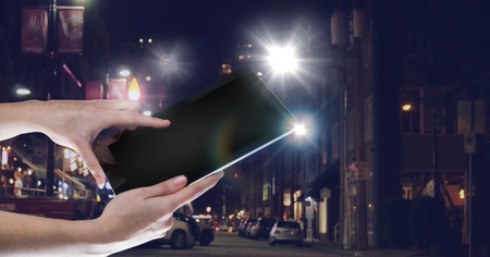 Digital composite of Hand holding tablet with glow