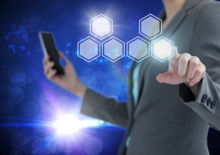 Digital composite of Hand touching icons interface of hexagonsの写真素材