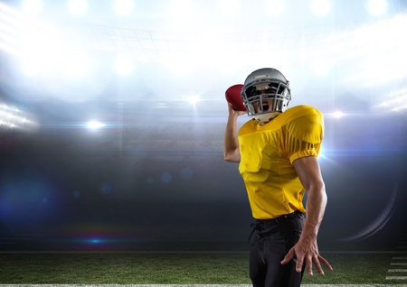 Digital composite of american football  player standing in stadium throwing the ballの写真素材