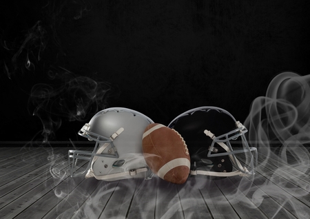 Digital composite of American football and helmets in smokeの写真素材