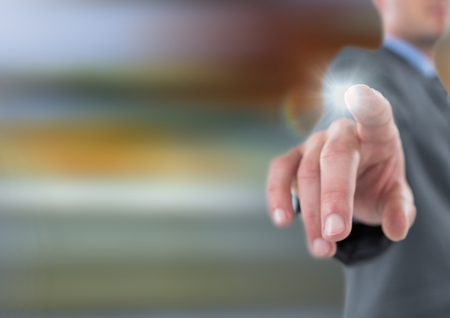 Digital composite of Hand touching the air with glowの写真素材