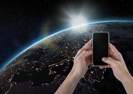 Digital composite of Hand holding phone with glowの写真素材