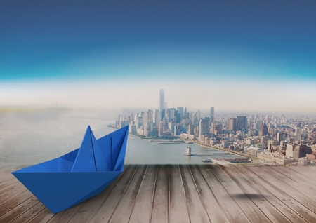 Digital composite of Paper boat over cityの写真素材