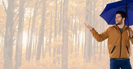 Digital composite of Man in Autumn with umbrella in bright forestの写真素材