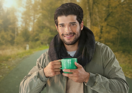 Digital composite of Man in Autumn with cup in forestの写真素材