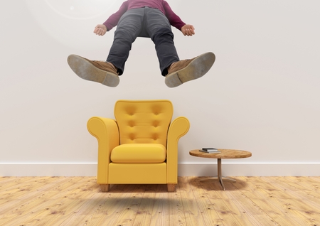 Digital composite of Man floating up from armchair in roomの写真素材