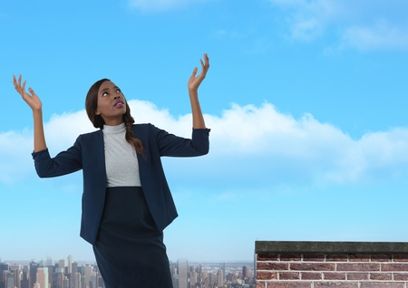 Digital composite of Businesswoman opening arms up to the sky confused and disappointedの写真素材