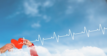Digital composite of Heart beat over hands holding heart in cloudsの写真素材