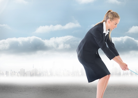 Digital composite of Businesswoman pulling rope over cityの写真素材