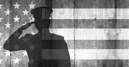 Digital composite of veterans day soldier in front of flagの写真素材