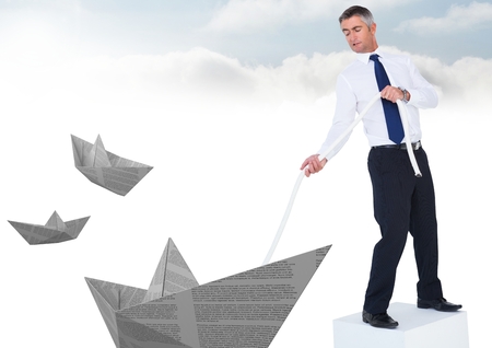 Digital composite of Businessman with paper boats and rope in skyの写真素材