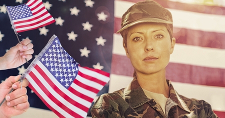 Digital composite of veterans day soldier in front of flagの写真素材