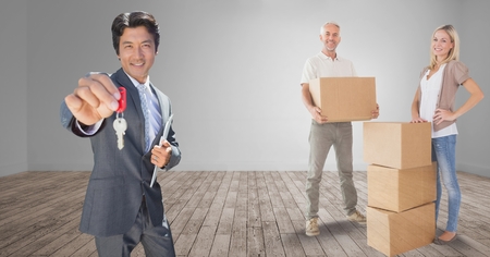 Digital composite of people moving boxes into new home with keyの写真素材