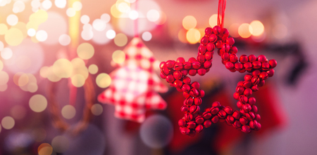 Close-up of christmas ornaments hanging on ribbon at homeの写真素材