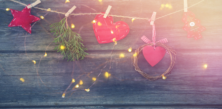Christmas decoration arranged on rope against wooden surfaceの写真素材