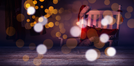 Close-up of plank against wooden chair with red pillow and santa hatの写真素材