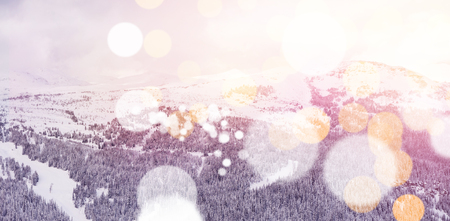 Scenic view of snowcapped mountains with bokeh in foregroundの写真素材