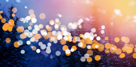 Scenic view of snow covered trees and mountains with bokeh in foreground