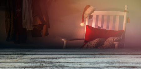 Full frame shot of weathered plank against wooden chair with red pillow and santa hatの写真素材
