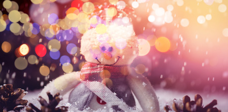 Snowman and pine cone on snow during Christmas timeの写真素材