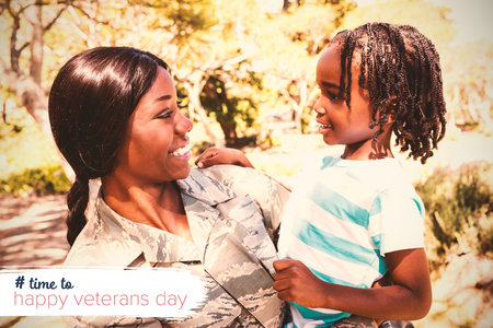 Logo for veterans day in america hashtag against happy family posing togetherの写真素材