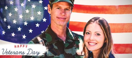 Logo for veterans day in america  against american soldier reunited with his partnerの写真素材