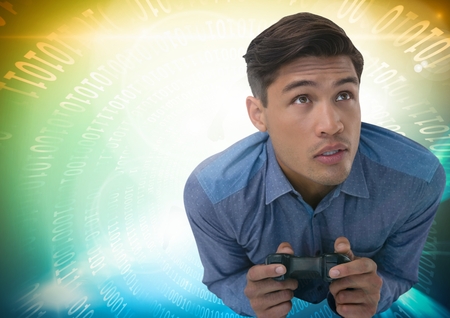 Digital composite of man playing with computer game controller with bright colorful background