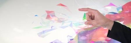 Digital composite of Hand interacting and touching air with bright colorful polygons background