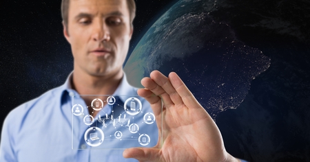 Digital composite of man holding glass interfaceの写真素材