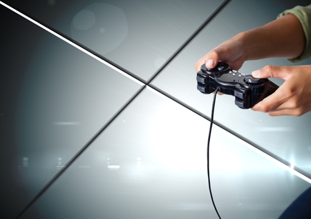 Digital composite of Hands playing with computer game controller with geometric minimal shiny lines...