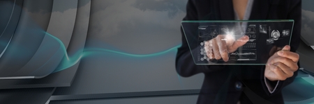 Digital composite of woman holding glass interfaceの写真素材