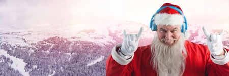 Digital composite of Santa with Winter landscape and DJ party headphonesの写真素材