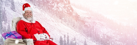 Digital composite of Santa Claus in Winter with giftsの写真素材