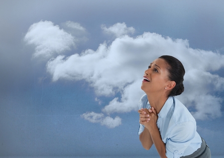 Digital composite of Desperate Businesswoman greiving and wailing for hope into the skyの写真素材