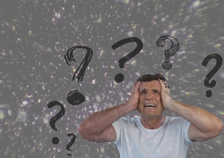 Digital composite of frustrated man with question marks