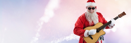 Digital composite of Santa Claus in Winter with guitarの写真素材