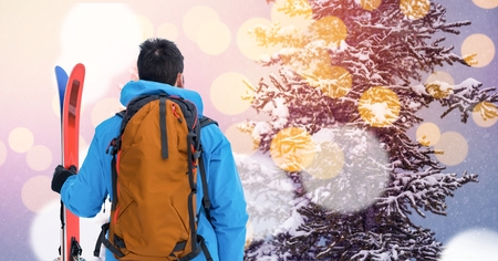 Digital composite of man standing with skiesの写真素材