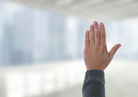 Digital composite of Hand open waving with bright windows in office