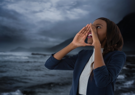 Digital composite of Businesswoman shouting by sea at nightの写真素材