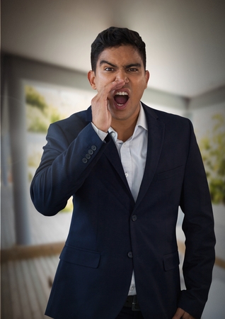 Digital composite of Businessman shouting and calling by windowsの写真素材