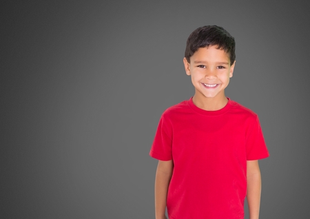 Digital composite of Boy against grey background smilingの写真素材
