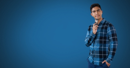 Digital composite of Businessman thinking with blue backgroundの写真素材