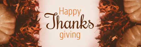 Thanksgiving greeting text against overhead view of pumpkins and autumn leavesの写真素材